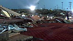 Collapsed bowling alley amid rubble