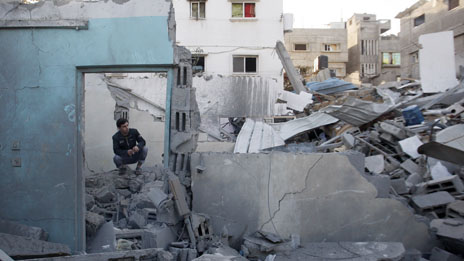 A Palestinian man inspects the damage to a house, after an Israeli airstrike in Jabaliya north Gaza.